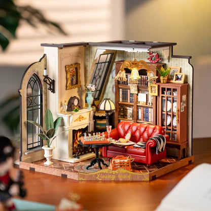 Miniature Catherines living room diorama with a red couch, fireplace, bookshelf, and chess set