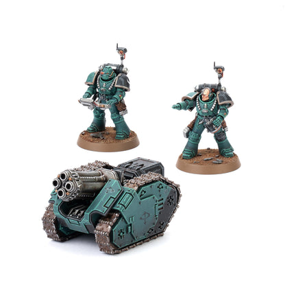 Two dark teal armored space marine miniatures stand beside a Legiones Astartes Rapier Laser Destroyer tank with tracks and a large gun