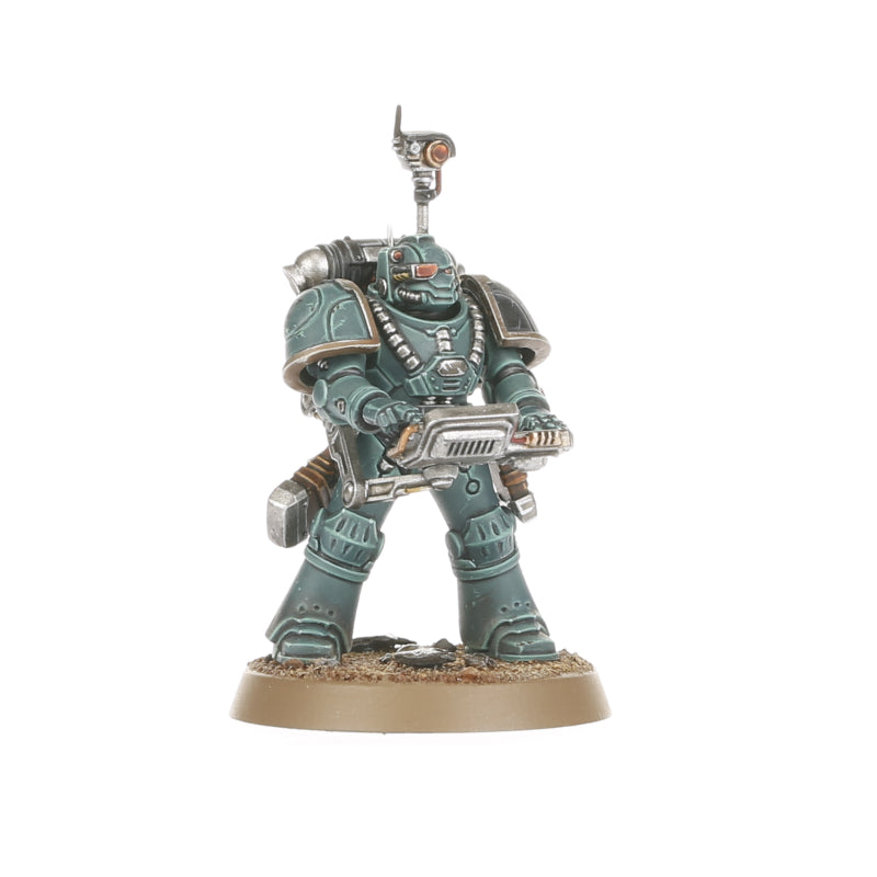 A teal armored Legiones Astartes miniature holding a large gun with a head-mounted scanner on a textured base