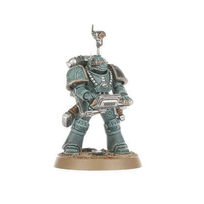 A teal armored Legiones Astartes miniature holding a large gun with a head-mounted scanner on a textured base