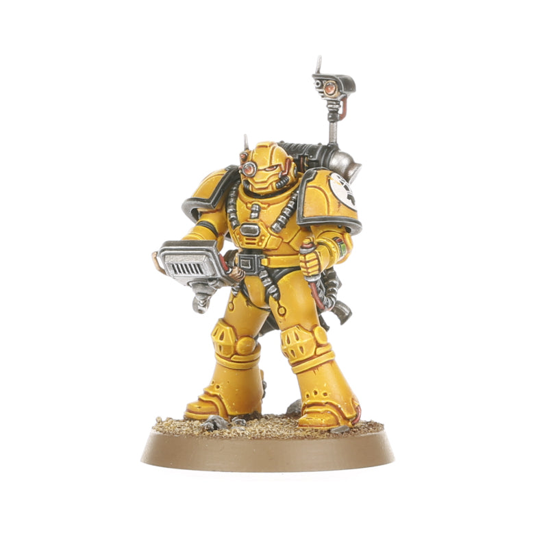 A painted yellow armored miniature figure resembling a space marine holding a scanner with a backpack and antenna, standing on a textured base