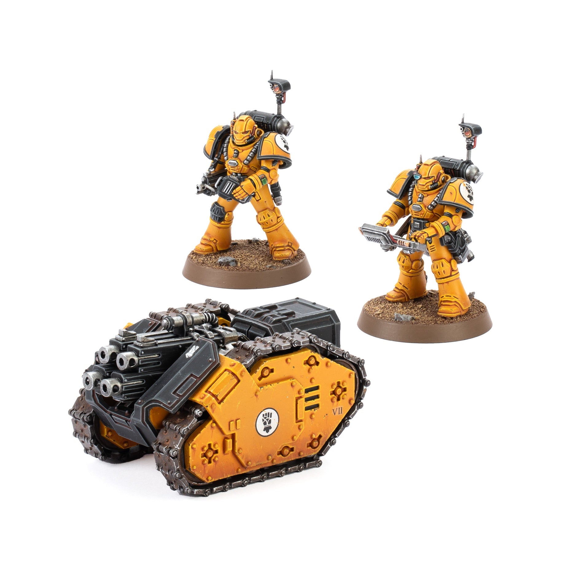 Two yellow armored Space Marine figures stand near a yellow and black Legiones Astartes Rapier Quad Heavy Bolters vehicle with tracks