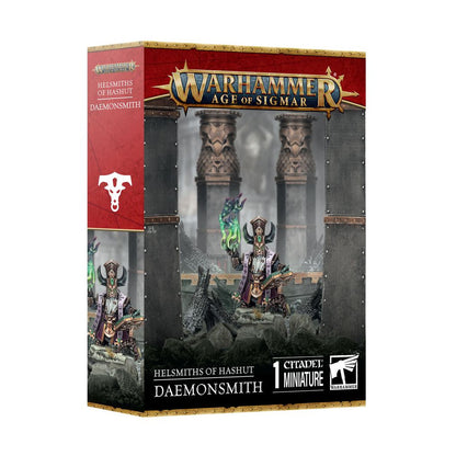 Retail box displaying the Warhammer Age of Sigmar Helmsmiths of Hashut Daemonsmith single Citadel Miniature with purple robes and glowing green magic