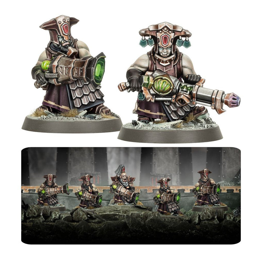 Fully painted Chaos Dwarf Infernal Razers miniatures, depicted with ornate helmets, dark armor, and large infernal weapons that emit a vibrant green light