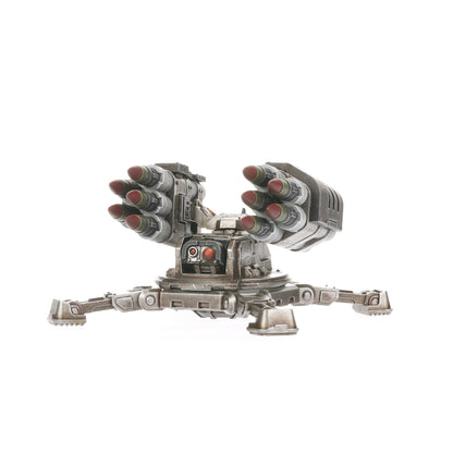 A Legiones Astartes Tarantula Missile Battery, a grey robotic turret with twin missile pods, resting on a tripod base with red sensor lights