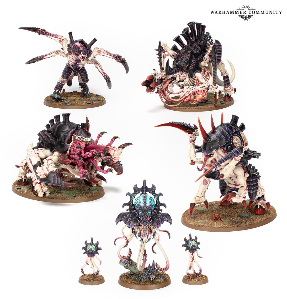 Seven highly detailed, painted Tyranid Crusher Stampede miniatures featuring dark carapaces and pale flesh are posed on scenic bases