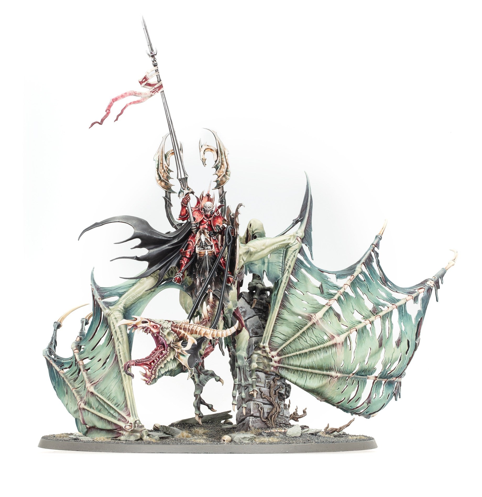 A detailed painted miniature of a Soulblight Gravelords vampire rider in red armor mounted on a skeletal undead dragon with pale ripped wings holding a tall banner spear