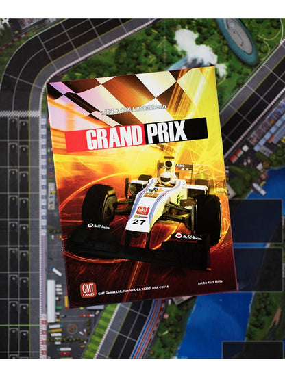 Grand Prix board game box showing a white race car and checkered flag, atop a racing circuit game board