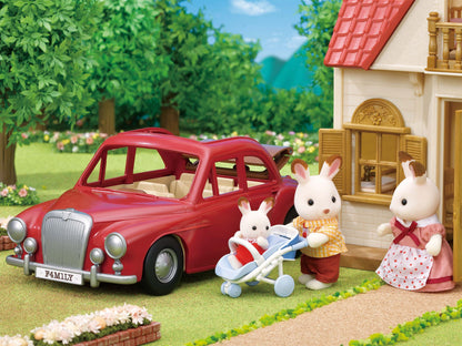 Sylvanian Families rabbit family with a baby in a stroller next to a red classic car and house