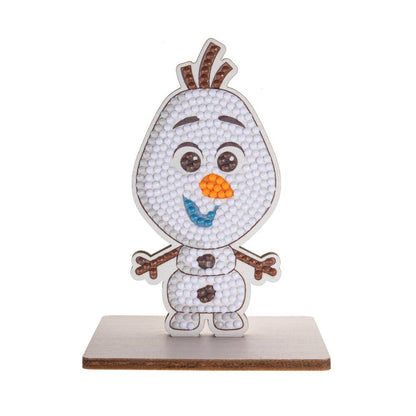This CrystalArt Buddies kit completed model shows Olaf the snowman standing on a wooden base, decorated with white, orange, and blue diamond dot crystals