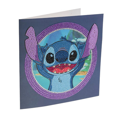 The 18x18cm Disney CrystalArt card shows a cheerful, rhinestone-studded Stitch raising his arms, framed by a sparkling purple circle