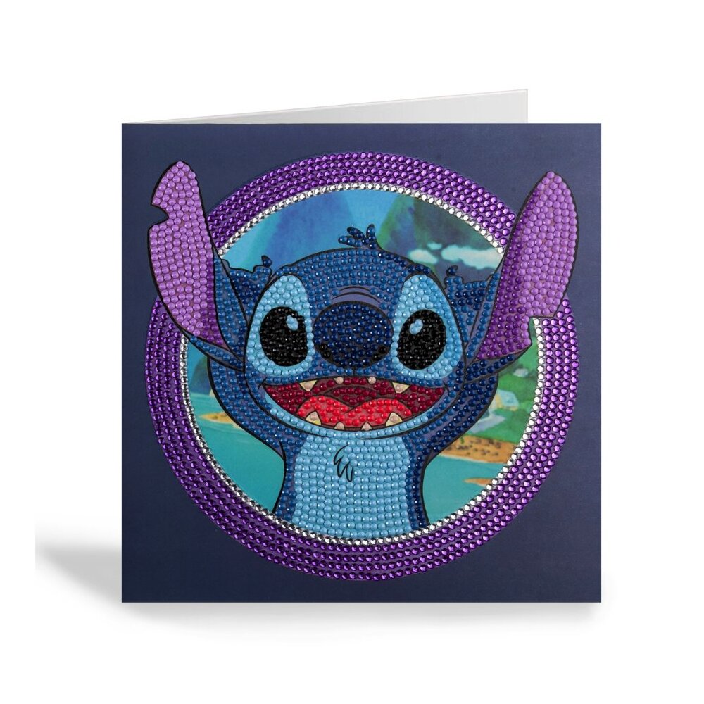 Disney's Stitch is depicted in sparkling blue and purple rhinestones on a square CrystalArt greeting card surrounded by a shimmering crystal ring
