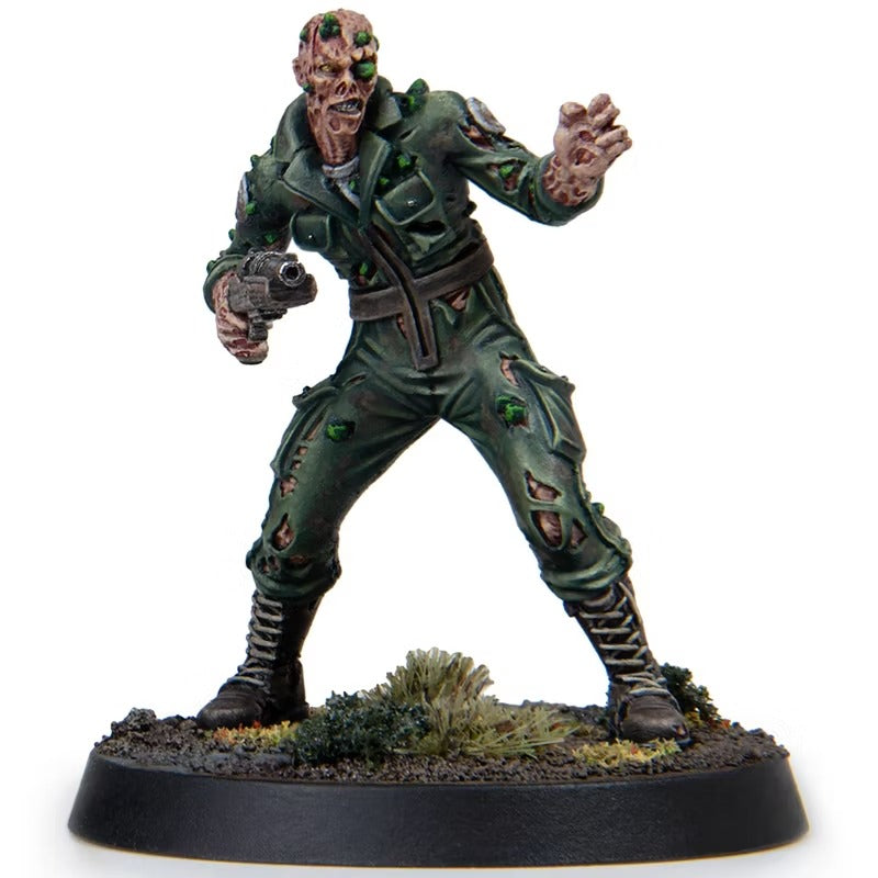 Mutated zombie miniature figure in a ragged green jumpsuit, holding a pistol