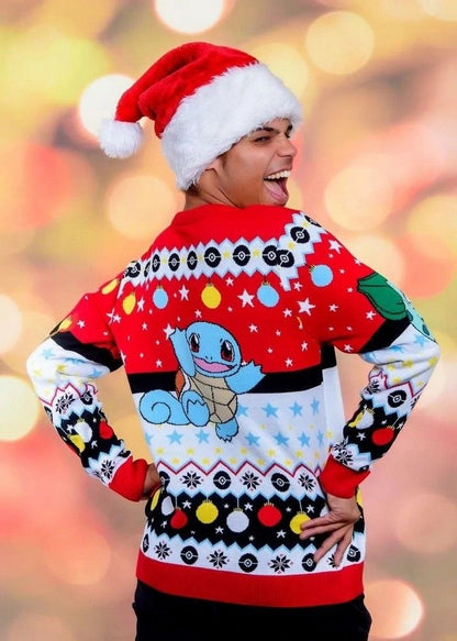 A model laughs happily while wearing a Santa hat and showing the back of a red Pokemon Christmas jumper featuring a large Squirtle character and festive ornaments