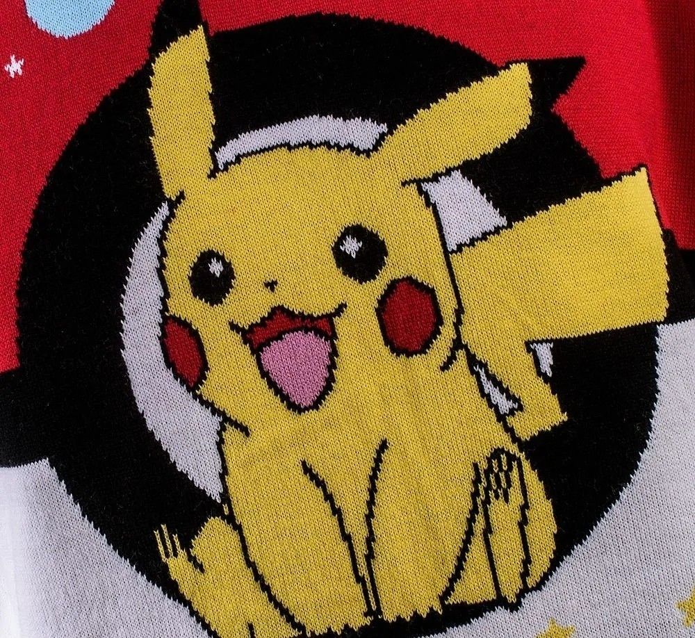 Close-up knitting detail of the Pokemon Christmas Jumper showing a cheerful Pikachu graphic knitted in yellow, black, and white threads against a vibrant red background