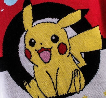 Close-up knitting detail of the Pokemon Christmas Jumper showing a cheerful Pikachu graphic knitted in yellow, black, and white threads against a vibrant red background