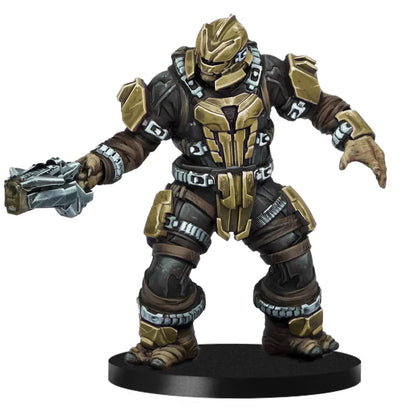 A highly detailed HALO Jiralhanae Brute miniature in black and bronze armor stands posed on a round black base holding a heavy weapon