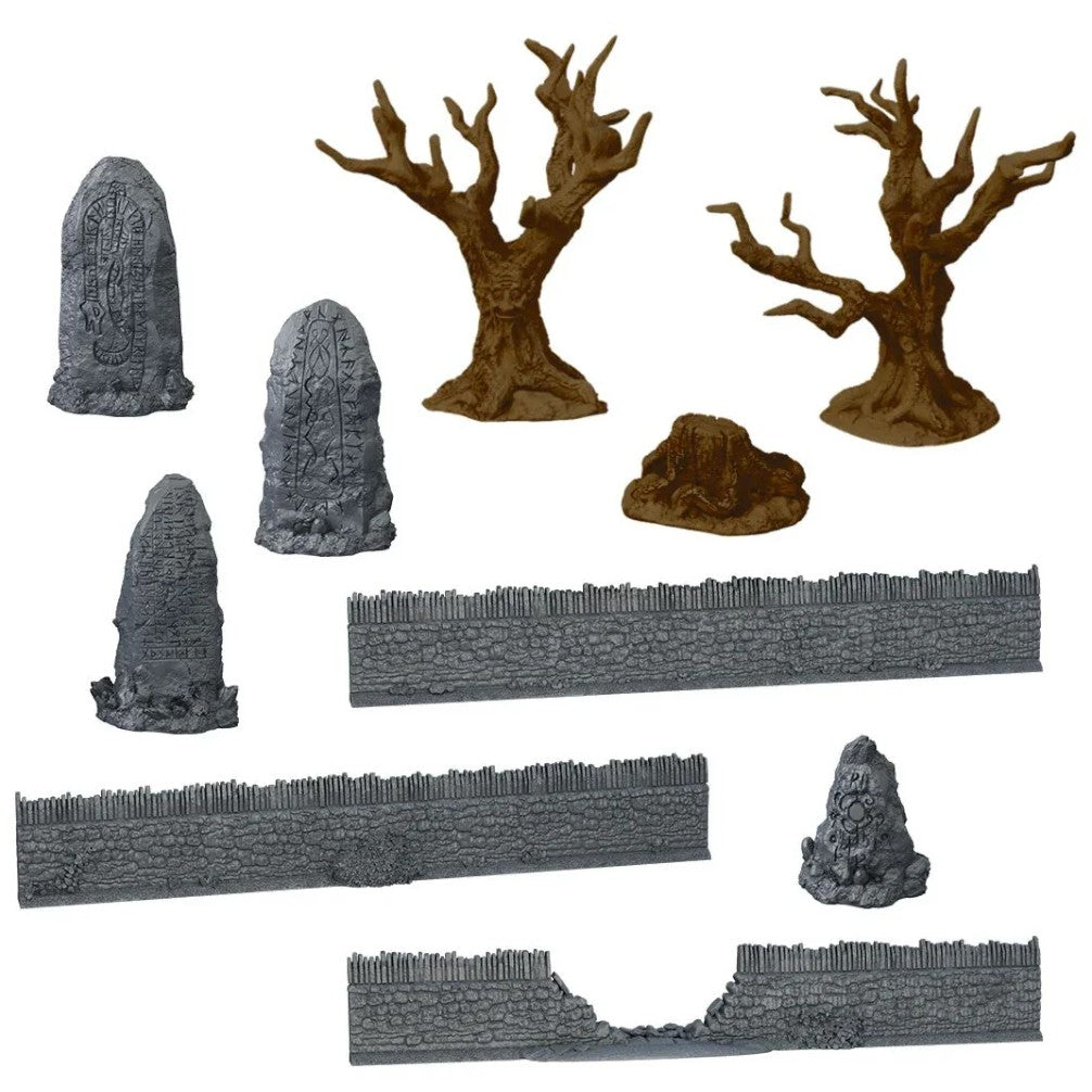 A collection of miniature fantasy terrain: grey stone walls with palisades, carved rune stones and leafless trees