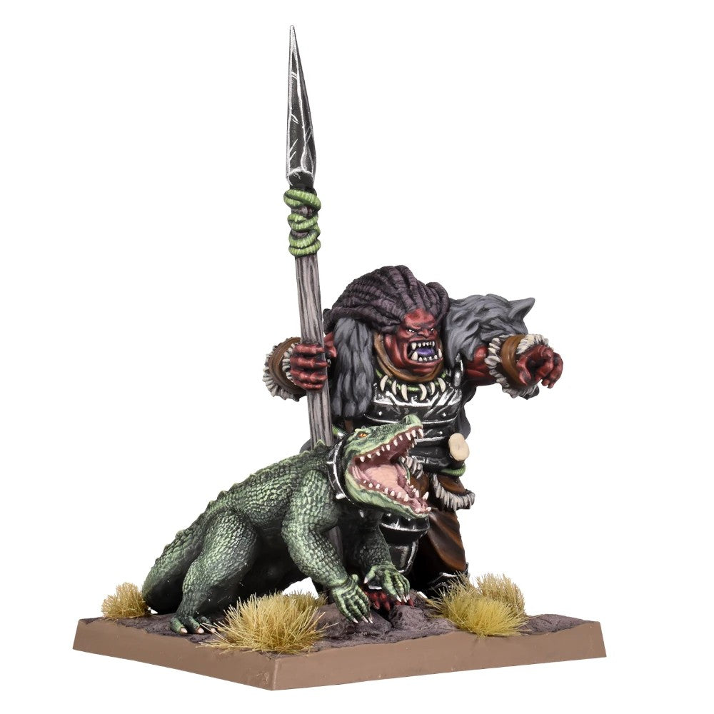 Miniature of an armored, red-faced orc-like warrior holding a spear, pointing, next to a green alligator with open jaws