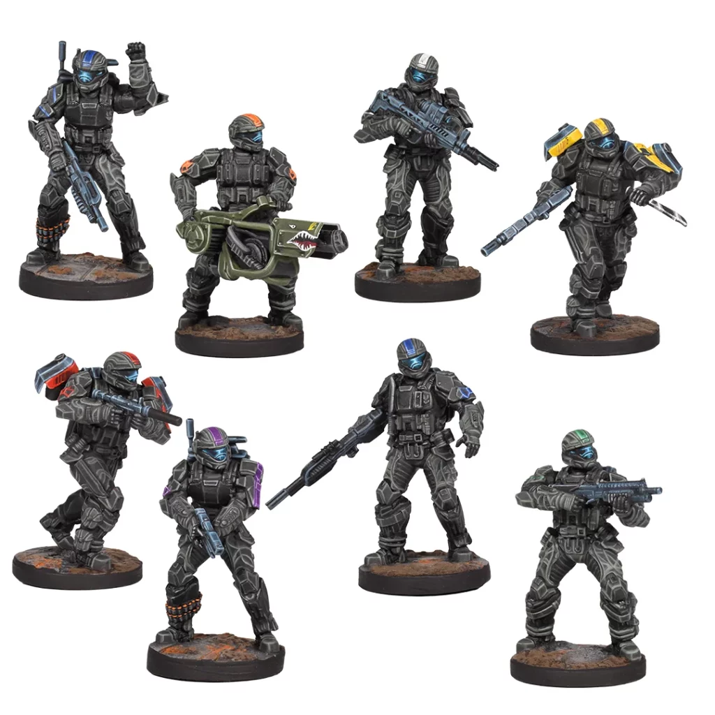 Eight dark gray Halo ODST miniatures are displayed, featuring different colored helmet stripes and holding various weaponry including a large shark-mouthed gun