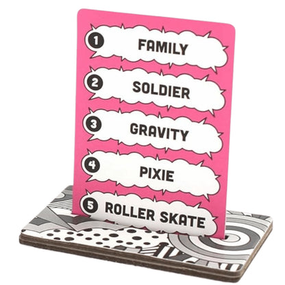 A pink card with five numbered words in speech bubbles stands upright in a patterned white, black, and gray base