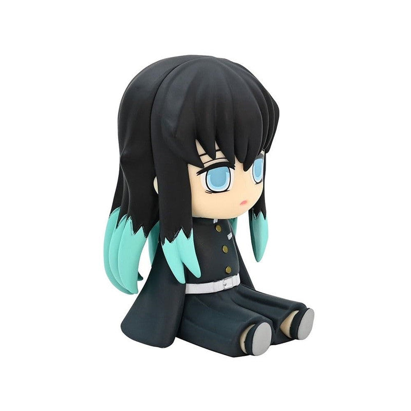 Chibi-style figure of a dark-haired character with blue-tipped hair and blue eyes wearing a dark uniform sitting down