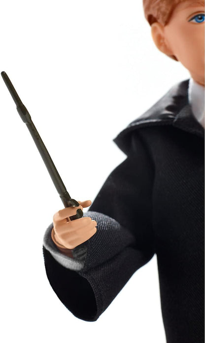 A Ron Weasley doll in black robes holds a magic wand