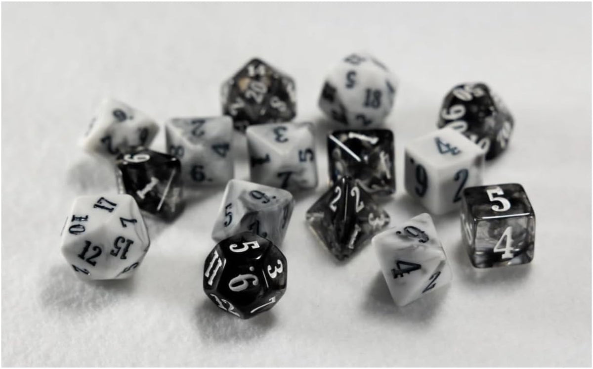 A collection of monochrome marbled polyhedral dice, in various shapes, scattered on a white surface.