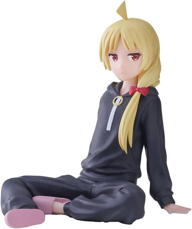 Figure of a girl with red bow in ponytail wearing a gray hoodie and pants sitting with pink slippers
