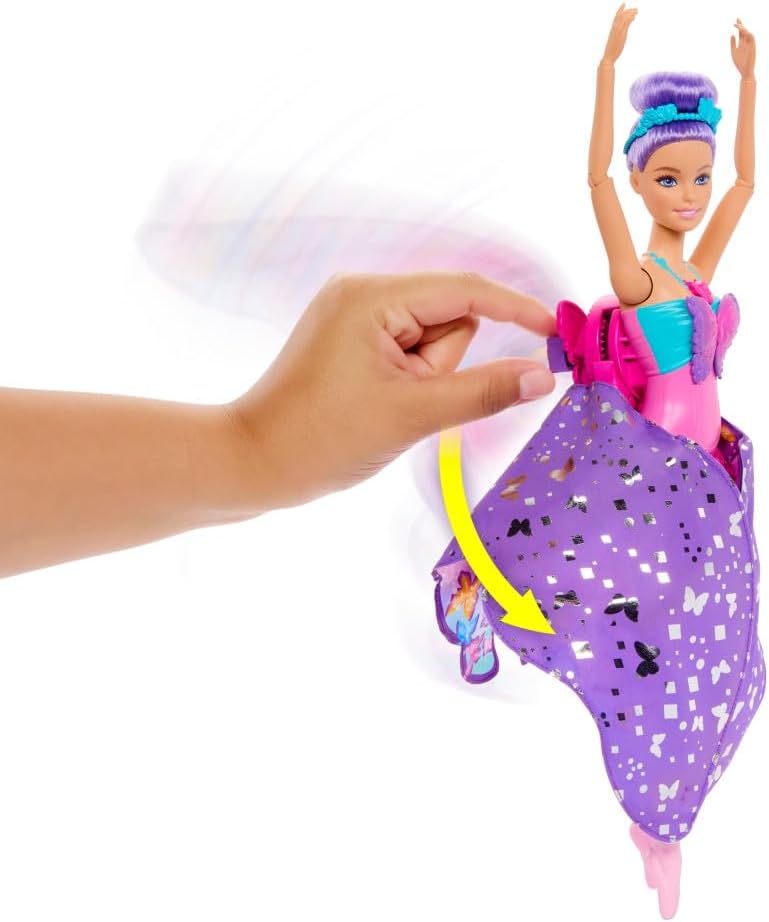 Hand activates purple-haired Barbie doll -  transforming her glittery purple skirt into fairy wings