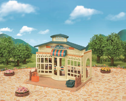 Detailed toy grocery market building with a striped awning, set outdoors on a stone patio