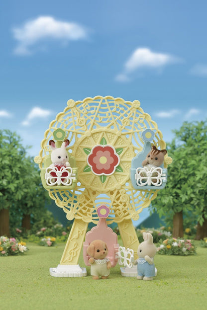Flocked critter figures riding a yellow musical Ferris wheel toy in a sunny park scene