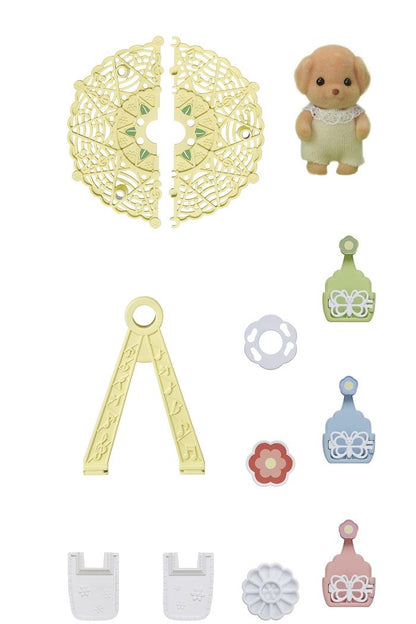 Flocked tan puppy toy figure surrounded by numerous miniature plastic accessories and decorative pieces