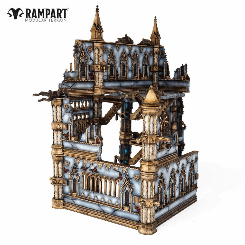 A detailed, ruined gothic building model in blue-grey and gold, designed as modular tabletop terrain