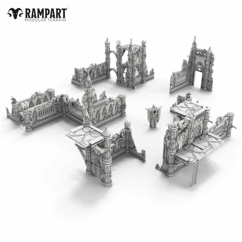 A collection of unpainted grey modular gothic ruin terrain for tabletop games, including walls, arches, and a statue