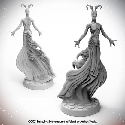 Two views of an unpainted Starfinder Asteray miniatures with antler-like heads, flowing robes, and outstretched arms