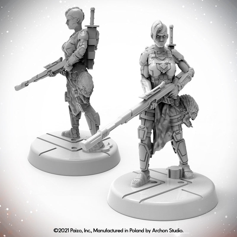 Two views of an unpainted Starfinder Android Xenoseeker miniature in armor, holding a rifle, with a sword on her back and an alien trophy