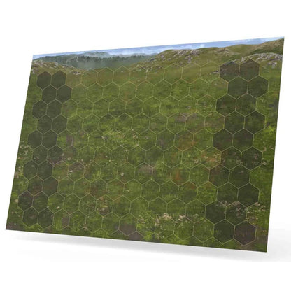 A hexagonal grid game mat for Heroes of Might and Magic III The Board Game Battlefield Expansion, featuring a lush green field and distant mountains