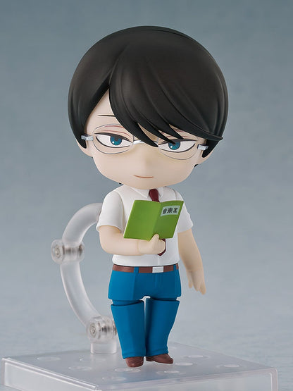 Nendoroid figure of a male student in glasses and school uniform, holding a green book with "Music Room" text
