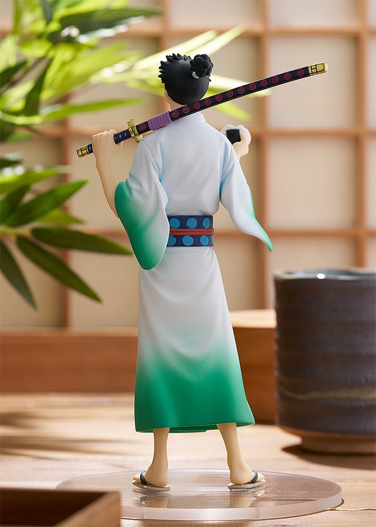 Back view of an anime character figurine in a white-green kimono, holding a katana on shoulder and a rice ball