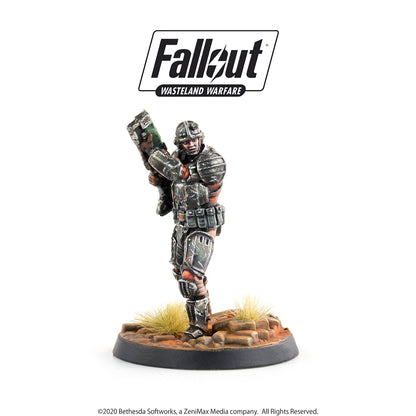 Fallout Wasteland Warfare miniature: A grim, armored soldier holds a large rifle in a combat pose on a desert base