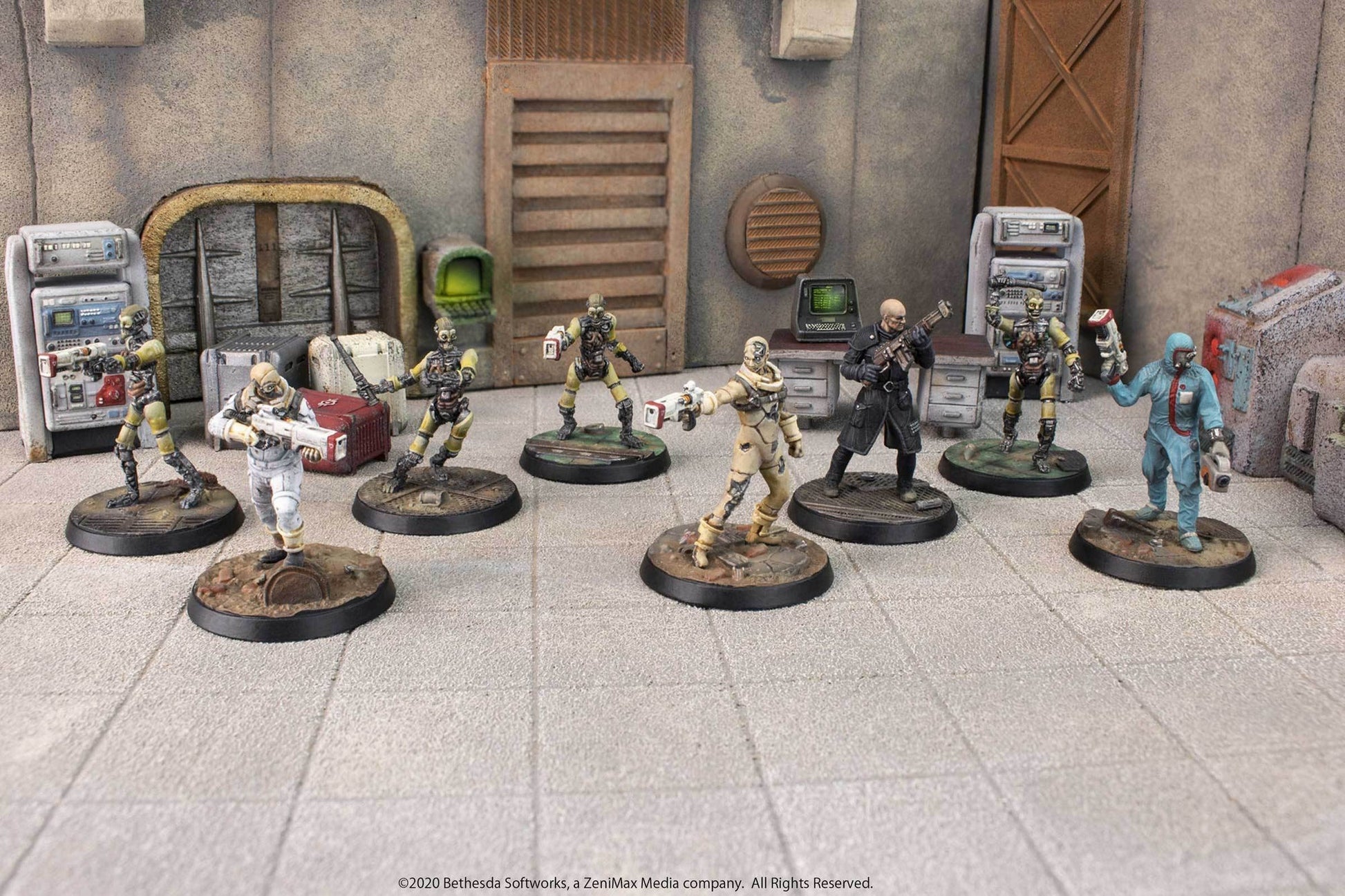 Seven armed sci-fi miniatures, including humanoids and cyborgs, posed in a detailed industrial setting on a tiled floor
