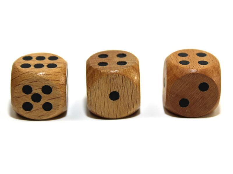 Three wooden dice with black pips on a white background 