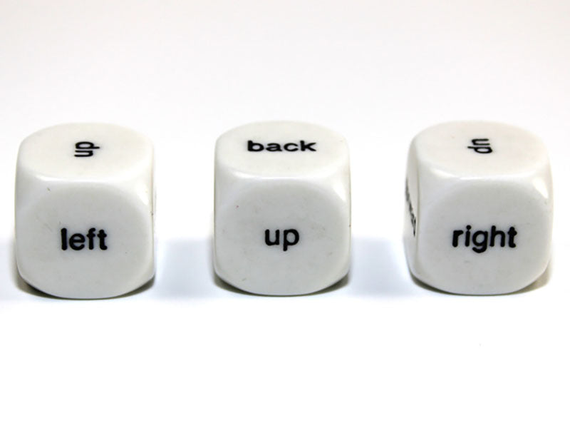 Three white 6 sided dice with black Direction - Up Down Left Right Back Forward showing on a white background