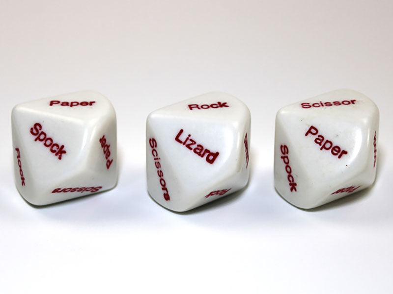 Three white dice displaying "Rock Paper Scissors Lizard Spock" game words in red text on a white surface 