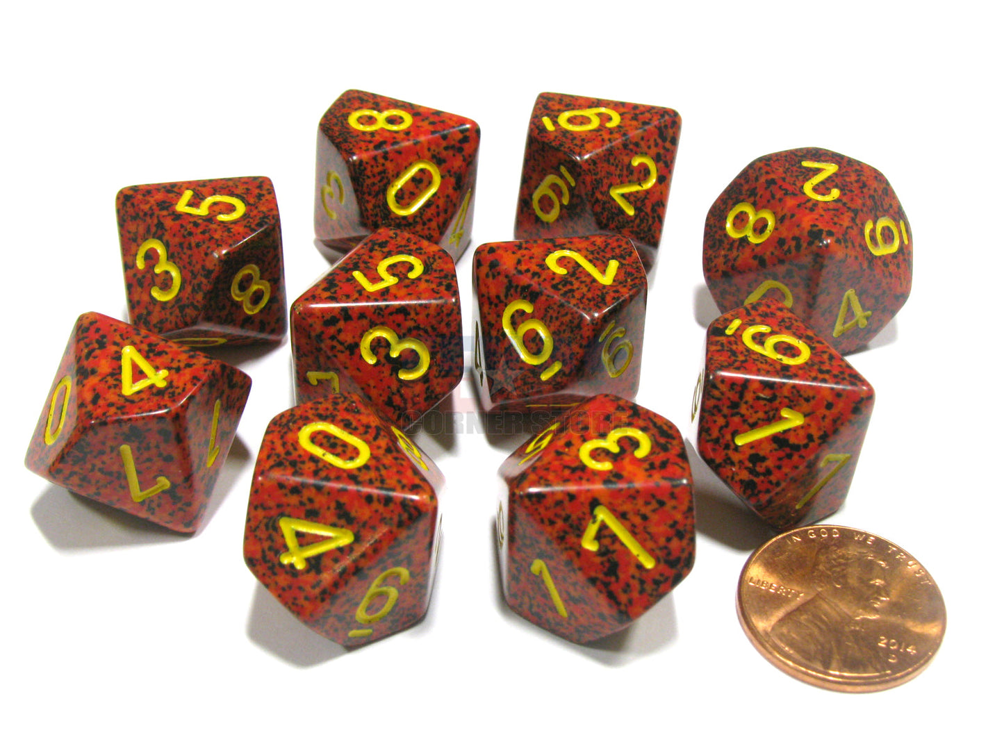 A 10-piece set of speckled red d10 dice with yellow numbers lies on a white surface, with a penny providing scale