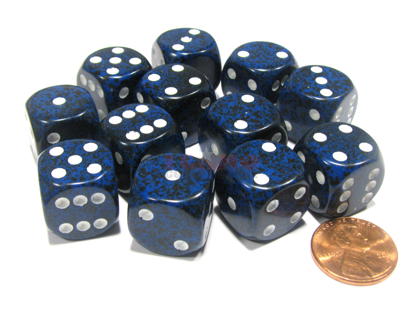 Twelve 16mm six-sided dice in a dark blue speckled pattern with bright white pips are shown on a white surface, resting near a copper penny