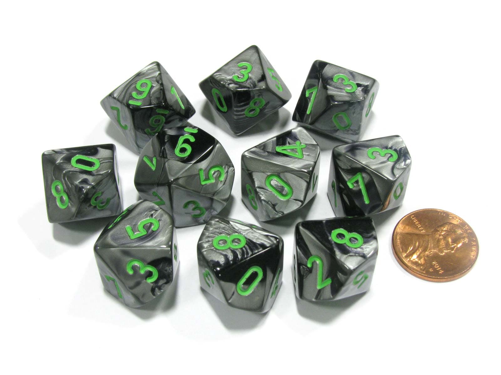A 10-piece set of Chessex Gemini d10 dice in black and grey swirl with bright green numbers and a penny for scale