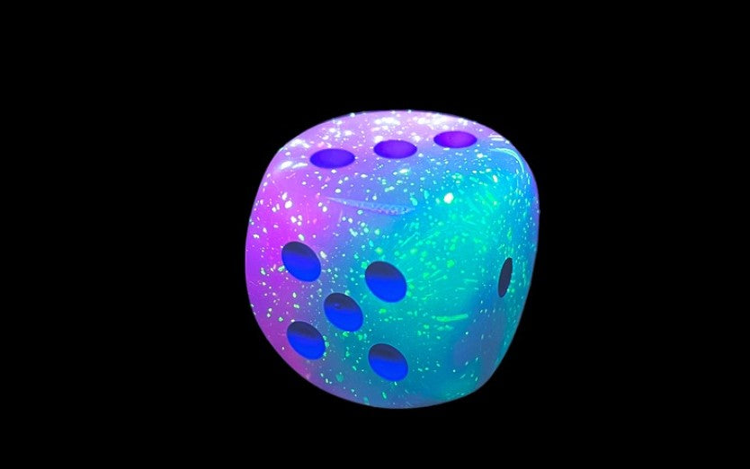 Gel Green Pink and Blue Luminary die showing 5, 3 and 1 faces with blue pips visible, on a white background