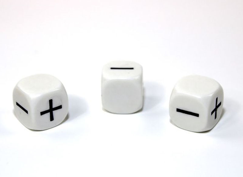 White die showing + and - faces on a white background